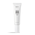 NACIFIC Phyto Niacin Brightening Essence bottle with fresh leaves and a lemon on a marble surface.