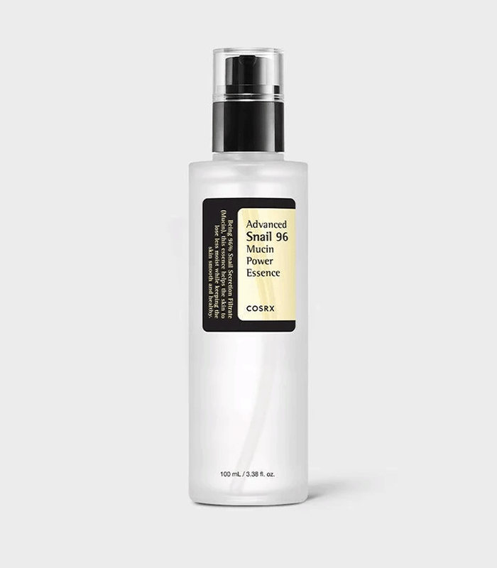 Woman applying COSRX Snail Mucin essence for hydrated skin - COSRX Snail Mucin