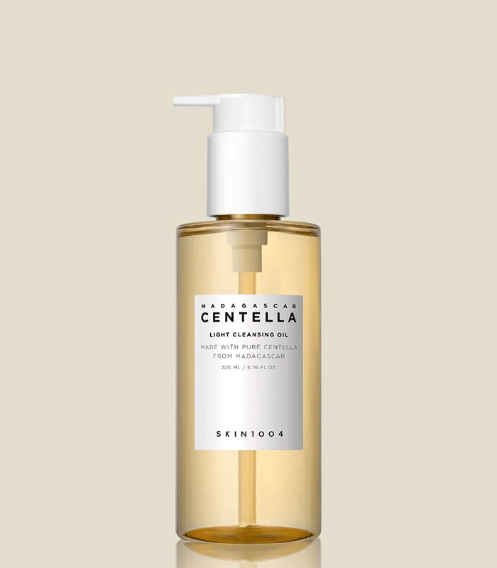 SKIN1004 Madagascar Centella Light Cleansing foam surrounded by skincare products on a vanity table